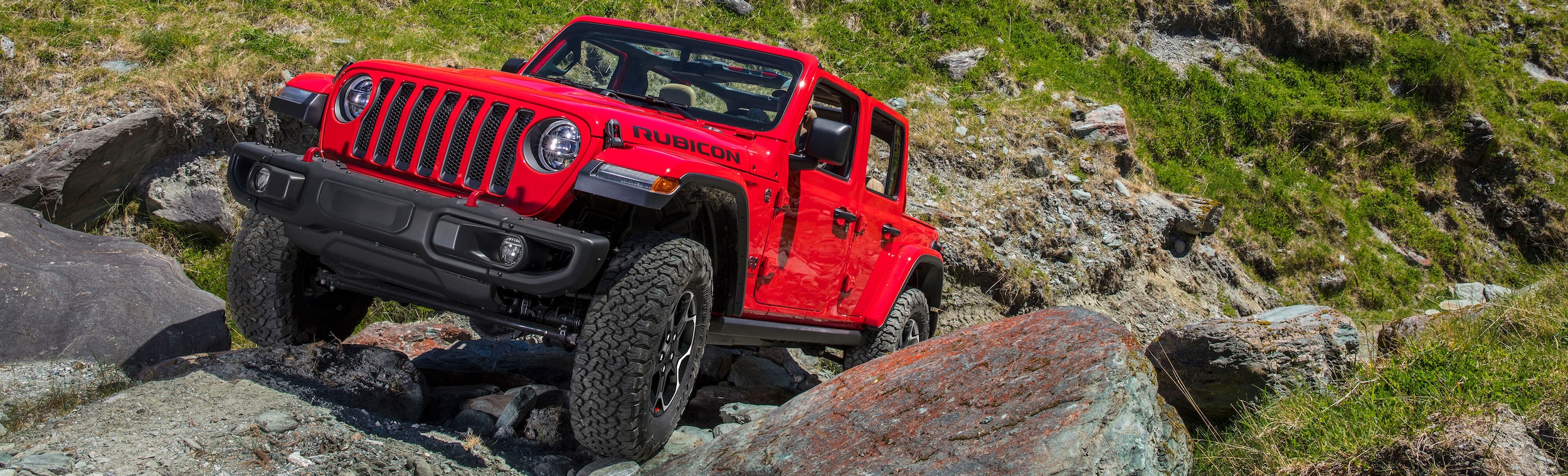 New Jeep Wrangler driving up rocks