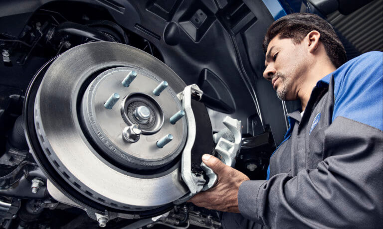 Ford Technician Working On Brakes