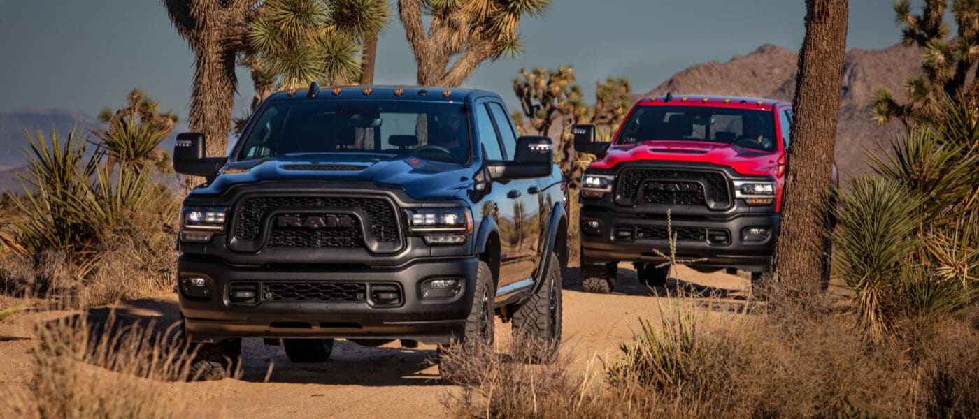 Two 2024 Ram 2500s offroading in the desert