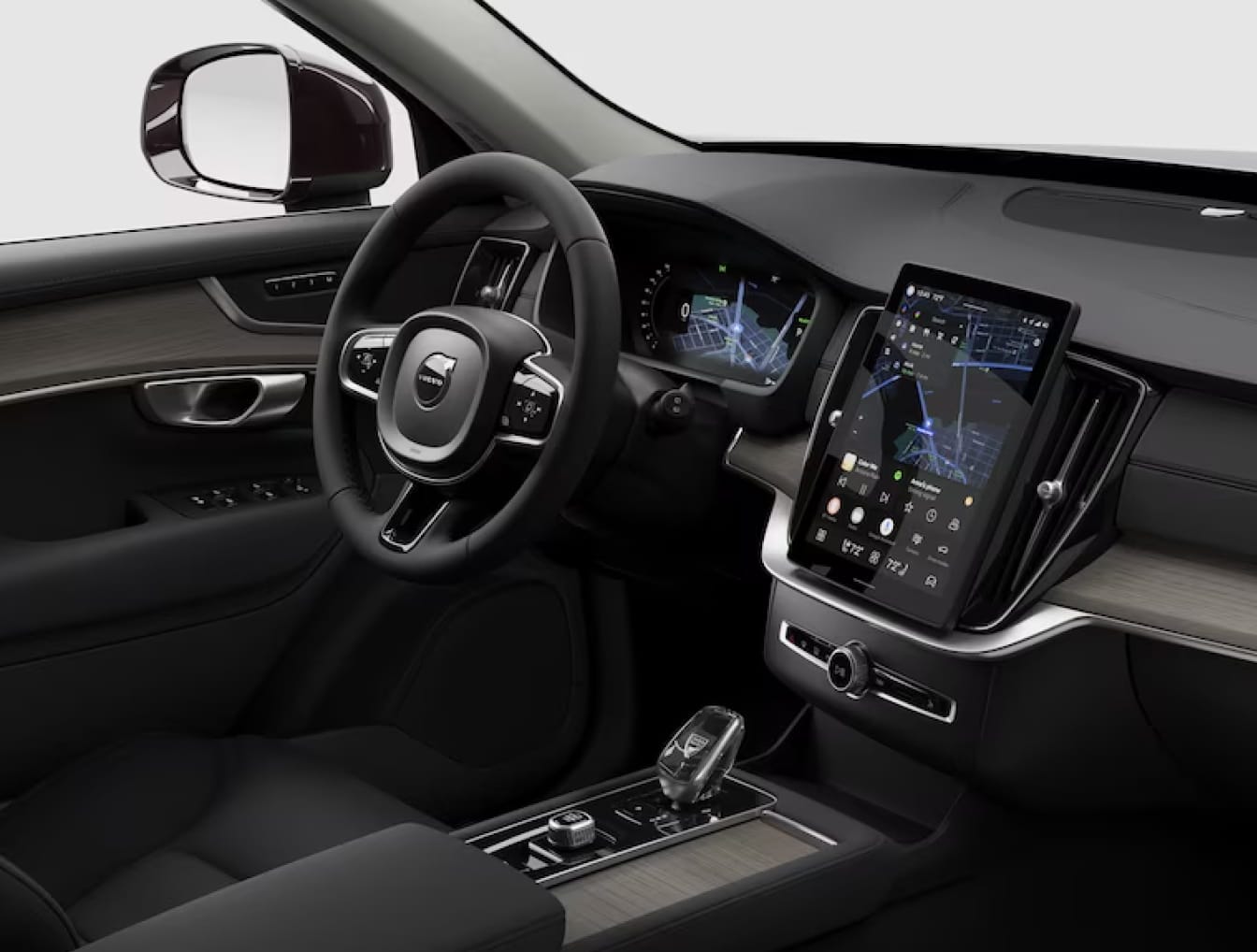 Volvo XC90 interior featuring a sleek steering wheel, digital dashboard with navigation, large touchscreen, and black leather seats.