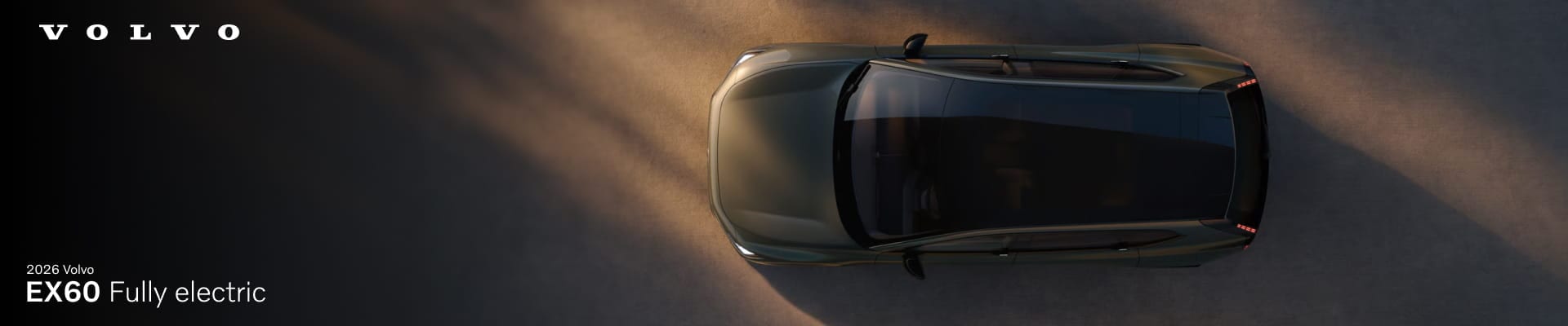 Top view of a 2026 Volvo EX60, fully electric, on a sunlit road.