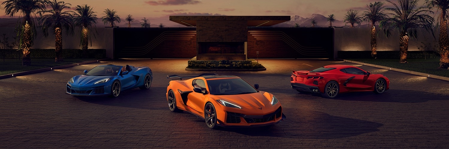 Three Chevy Corvette options in a lot parked in a semicircle at dusk