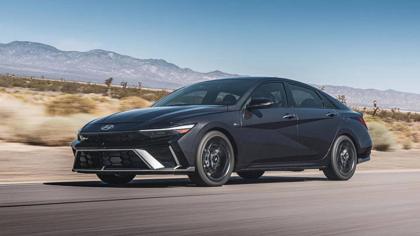2025 Hyundai Elantra driving dynamically on a city street.