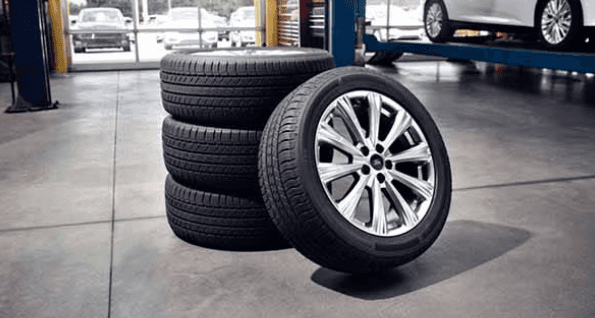 four stacked ford tires pictured for wheel alignment services