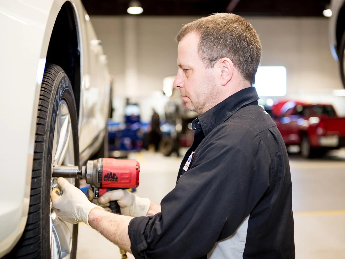 Rossi Chevrolet service technician working on a vehicle wheel