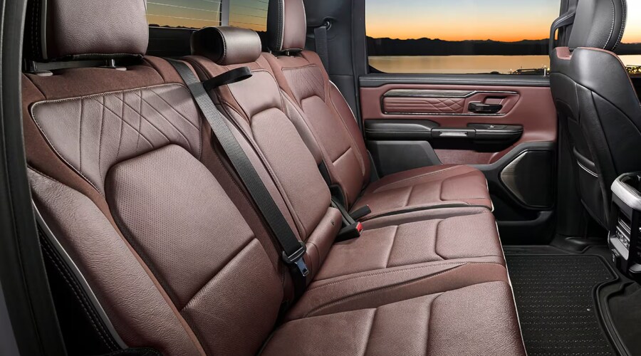 Interior view of a 2026 Ram 1500 Crew Cab showing the spacious rear seat legroom and under seat Ram Bins storage options