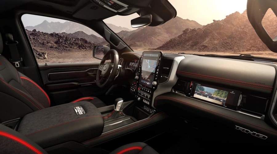 2026 Ram 1500 interior cabin featuring the vertical Uconnect 5 touchscreen navigation system and controls for on-board power, air suspension, and trailer assist setups at Route 18 CJDR serving East Brunswick and Middlesex County, NJ.