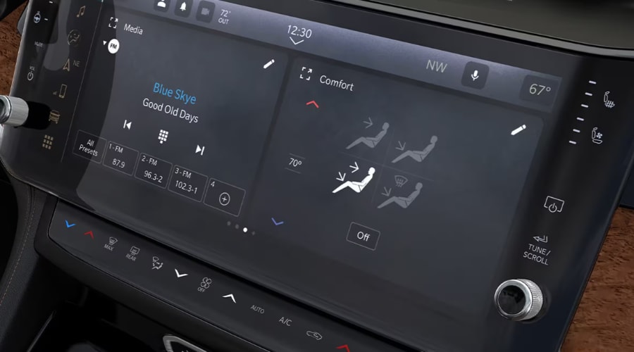Close-up of the 10.1-inch Uconnect 5 touchscreen display in a 2026 Jeep Grand Cherokee showcasing media playback and dual-zone climate comfort controls for East Brunswick and Edison, NJ drivers.