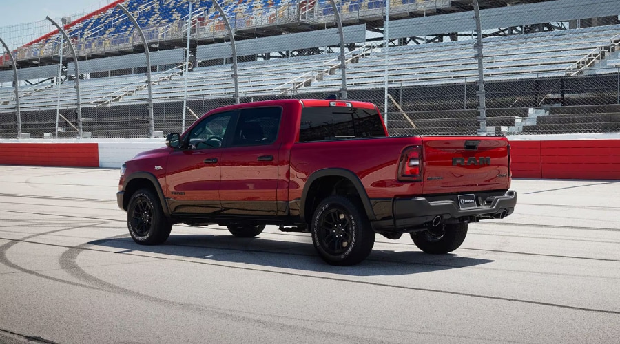 Rear view profile of a 2026 Ram 1500 Crew Cab driving through East Brunswick showing its spacious four door configuration