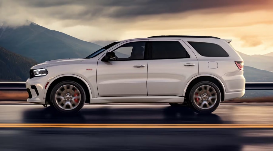 A sleek 2026 Dodge Durango accelerating smoothly down a Middlesex County highway showcasing its athletic stance