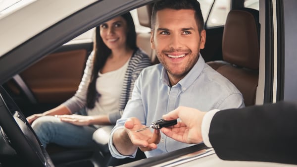 Salesperson handing keys to purchaser of a new Pacifica Hybrid