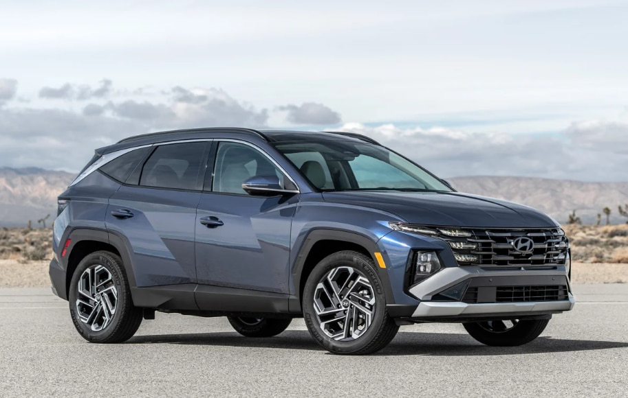 2026 Hyundai Tucson SUV in blue-gray front three-quarter view parked outdoors