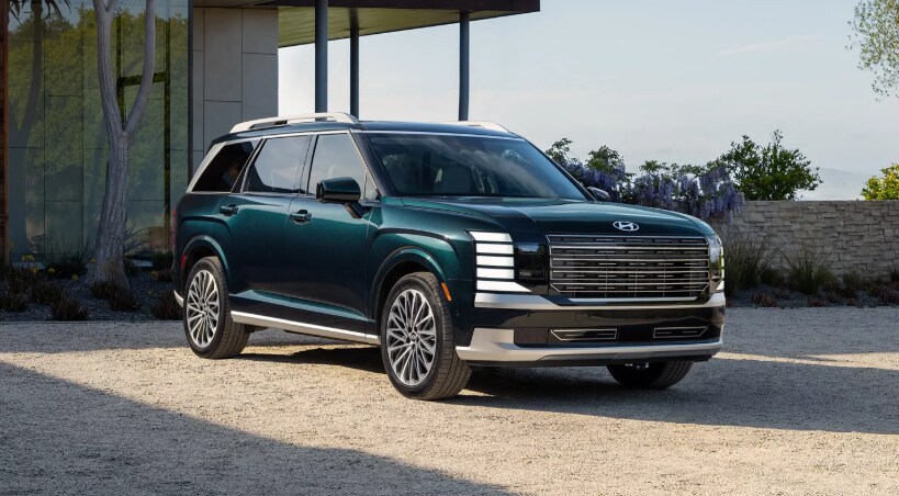 2026 Hyundai Palisade SUV in green parked outside modern home
