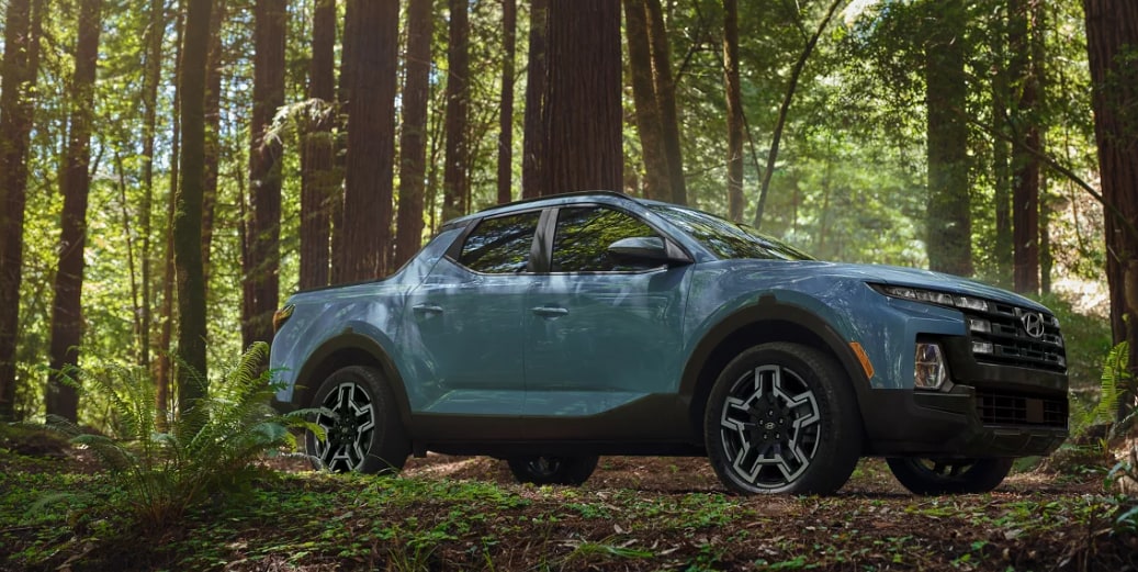 Baby Blue 2026 Hyundai Santa Cruz in the forest.