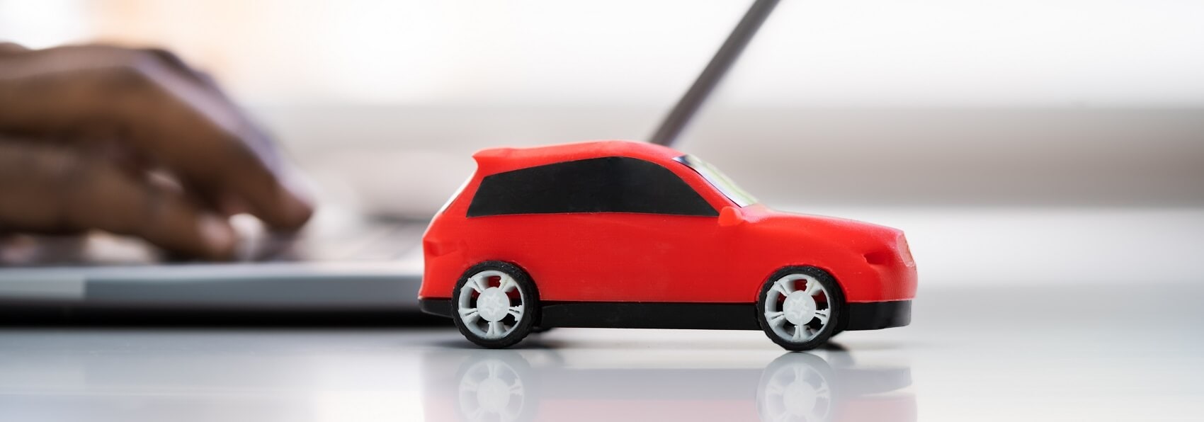 Red toy car on a desk