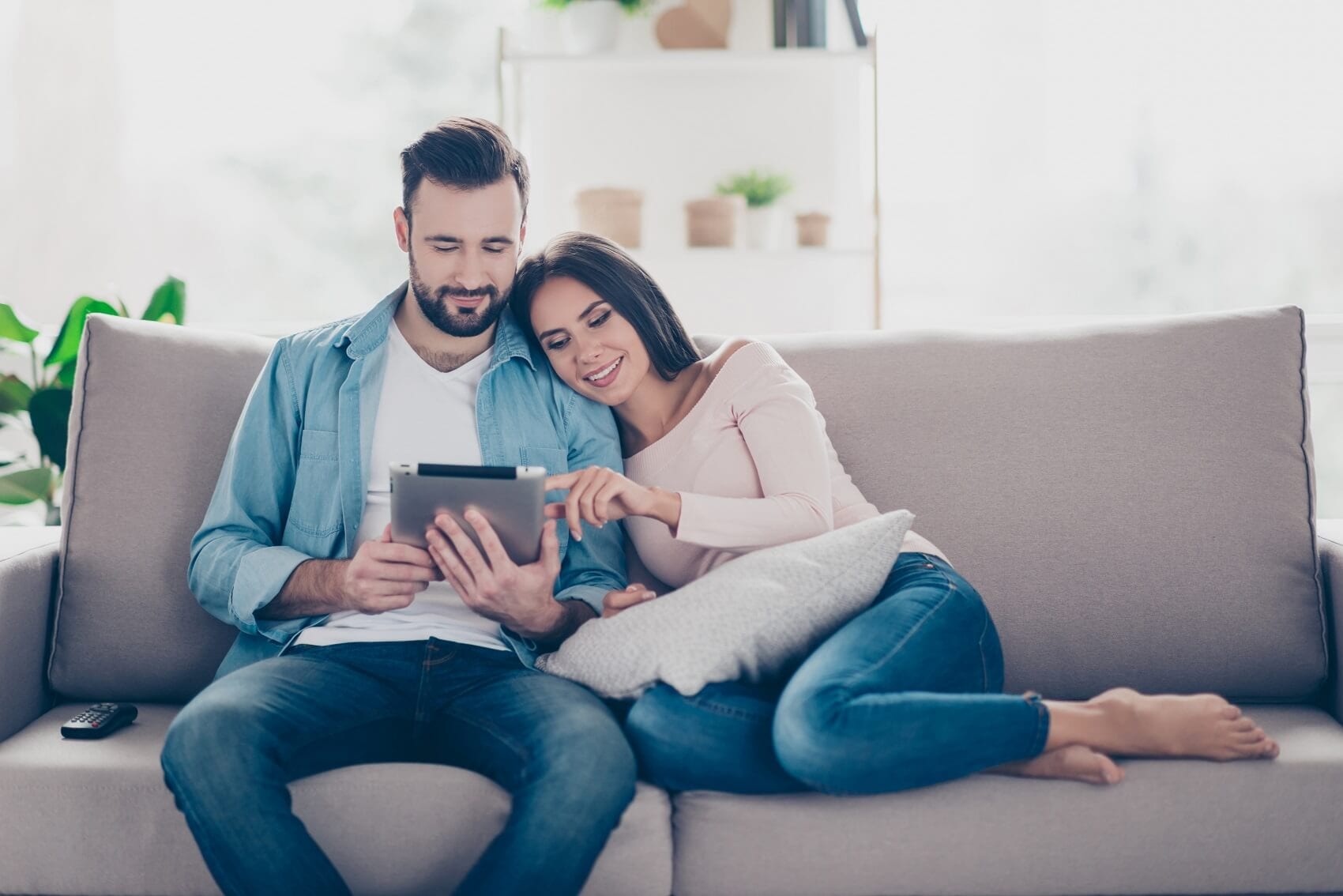 Couple researching Nissan vehicles on a tablet