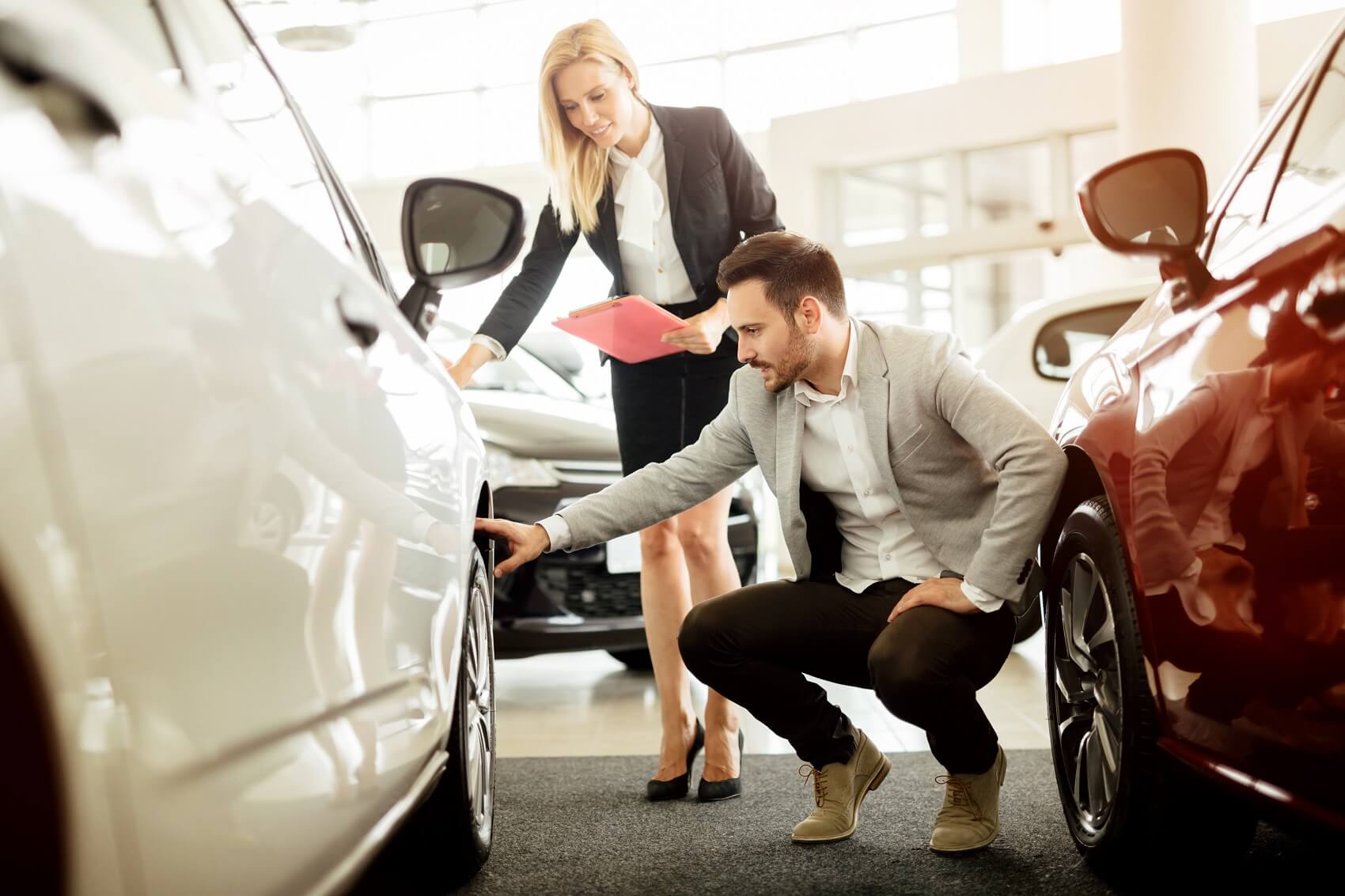 Man checking out a new Nissan at a dealership