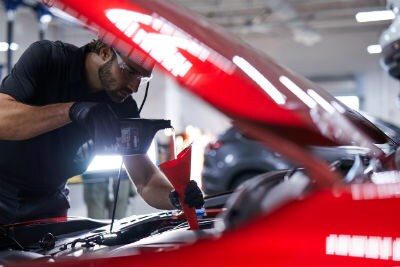 Mazda-technician-pouring-oil-into-engine-using-a-funnel_o.jpg