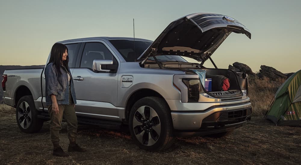  A silver 2022 Ford F-150 Lightning is shown with the front storage open after leaving a Rhinebeck Ford dealer.