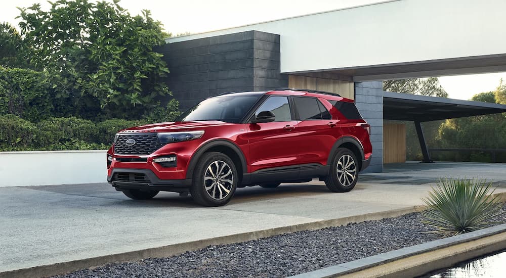 A red 2023 Ford Explorer ST for sale is shown parked in a driveway.