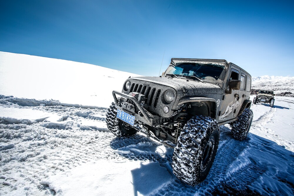 Jeep Wrangler Driving Through Snow