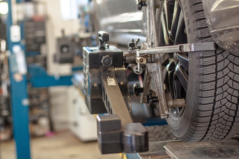  A Close up of a tire rotation being performed in a garage