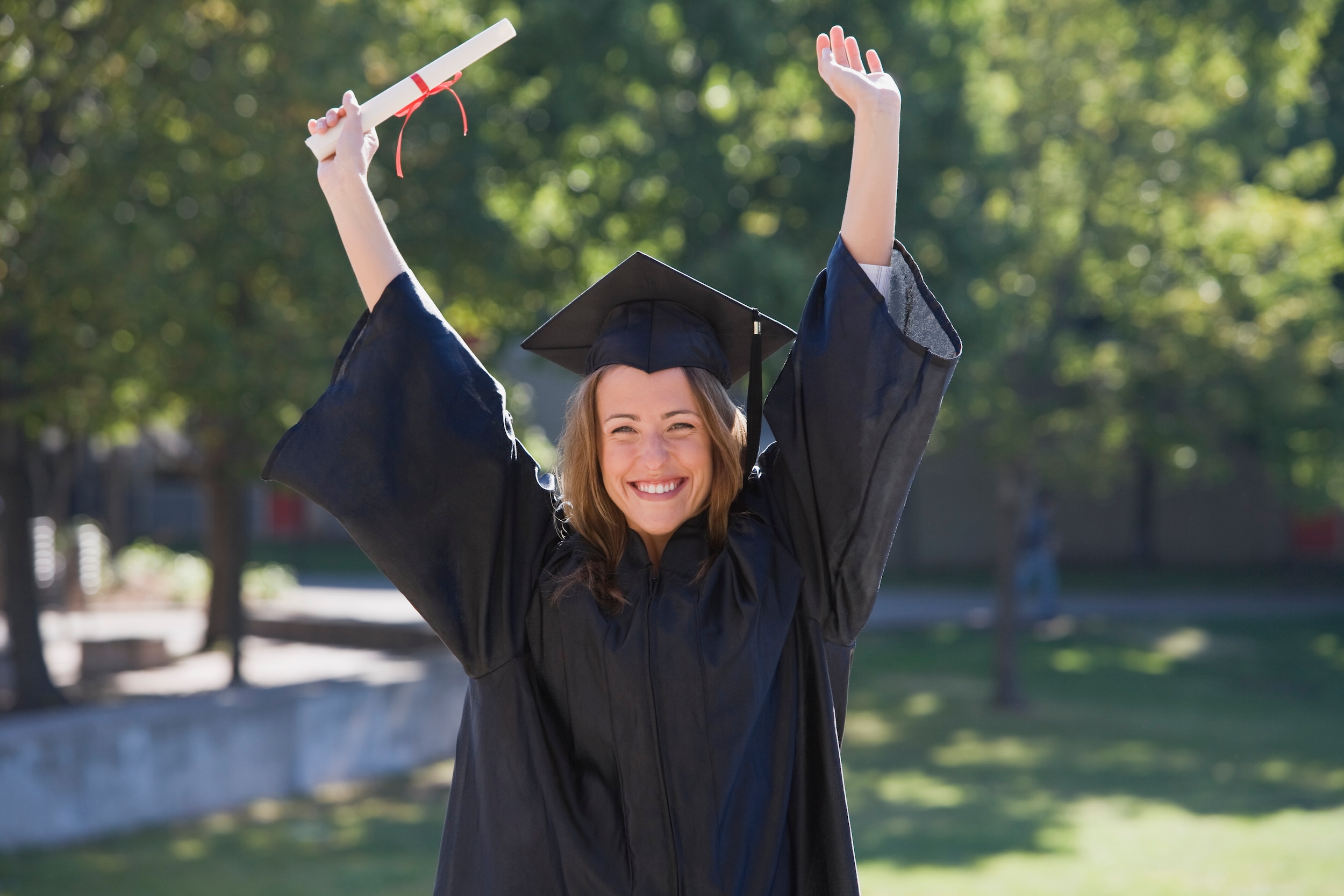 College Graduate Celebrating with Diploma