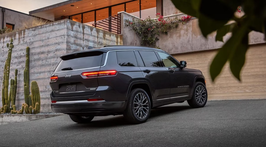 Rear view of a 2026 Jeep Grand Cherokee in Millburn highlighting its sleek LED taillights and restyled bumper configuration