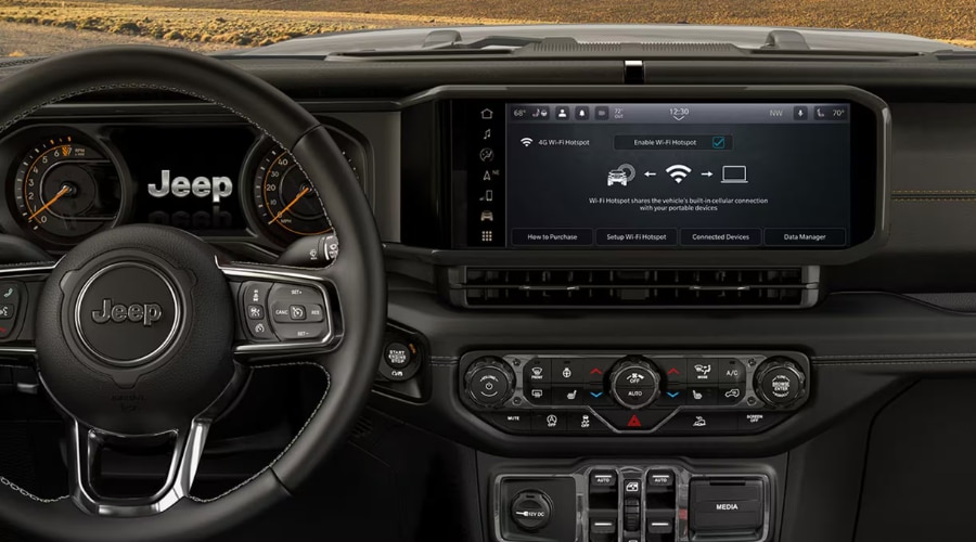 2026 Jeep Wrangler interior dashboard featuring the 12.3-inch Uconnect 5 touchscreen display with Wi-Fi hotspot menu, leather steering wheel, and climate controls for commuters in Summit, Morristown, and Union County, NJ.