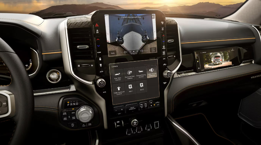 2027 Ram 1500 interior luxury dashboard featuring a 14.5-inch Uconnect 5 vertical touchscreen with split-screen trailer camera view and a 10.25-inch front passenger display at Salerno Duane Chrysler Jeep Dodge Ram in Summit, NJ. 