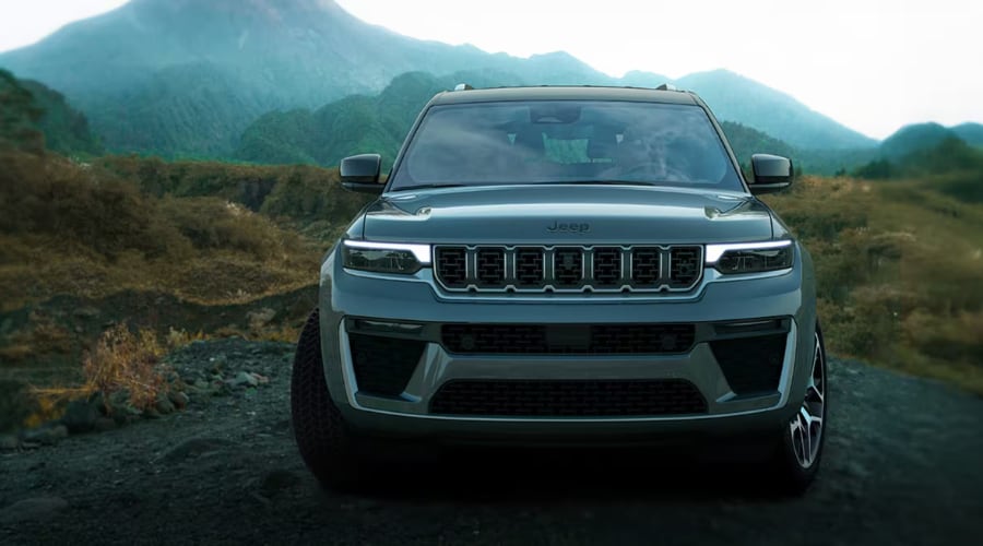 Head-on front view of a slate gray 2026 Jeep Grand Cherokee highlighting the iconic seven-slot grille and lower bumper thermal imaging camera housing used for Night Vision calibration at Salerno Duane CJDR near Summit, NJ in Union County.