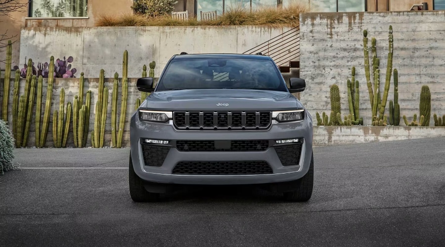 Front-end view of the grey 2027 Jeep Grand Cherokee featuring a blacked-out seven-slot grille and LED headlights, showcasing new updates available at Salerno Duane Chrysler Jeep Dodge Ram in New Jersey.
