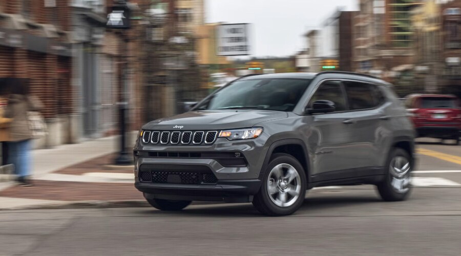2026 Jeep Compass driving on highway showcasing fuel-efficient performance