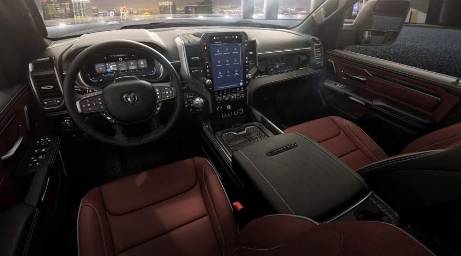 2027 Ram 1500 Limited front interior cabin featuring two-tone dark red and black leather bucket seats, a 14.5-inch Uconnect 5 vertical touchscreen, 12.3-inch digital gauge cluster, and front passenger screen at Salerno Duane Chrysler Jeep Dodge Ram in Summit, NJ.