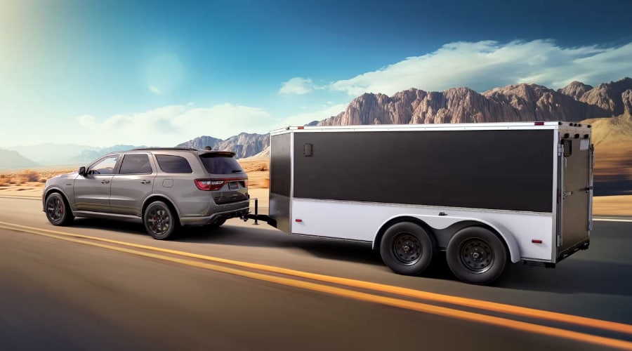 Rear view of a 2026 Dodge Durango towing a trailer through North Jersey showcasing its massive capability