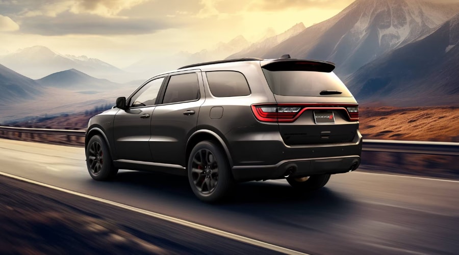 Front three quarter profile of a 2026 Dodge Durango driving through Summit New Jersey showcasing its aggressive muscle SUV styling