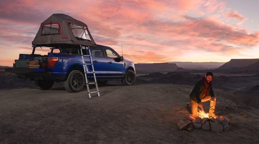 Side view of a 2026 Ford F-150 driving through Summit highlighting the aerodynamic sculpting and alloy wheels.