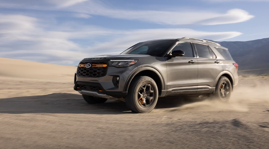 2026 Ford Explorer SUV kicking up trail dust on off-road terrain, demonstrating why front camera lenses and radar sensors require routine cleaning at Salerno Duane Ford in Summit, NJ