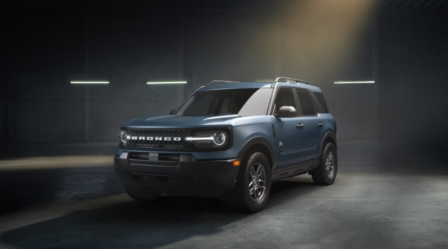 Front quarter studio view of a slate blue 2026 Ford Bronco Sport compact 4x4 SUV with signature round LED headlights, safari-style roof, and roof rails, available at Salerno Duane Ford near Summit and Morristown, NJ.