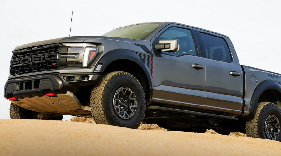 Low-angle view of the high-output 2026 Ford F-150 performance model, featuring an aggressive black grille and red tow hooks, on display near Union County