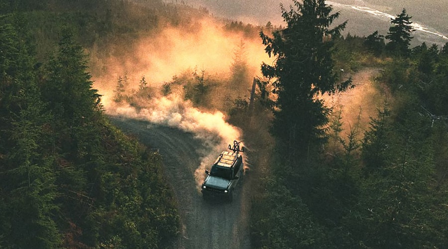 Aerial view of a 2026 Ford Bronco navigating a tight forest trail hairpin turn using Trail Turn Assist and G.O.A.T. modes near Chatham, NJ