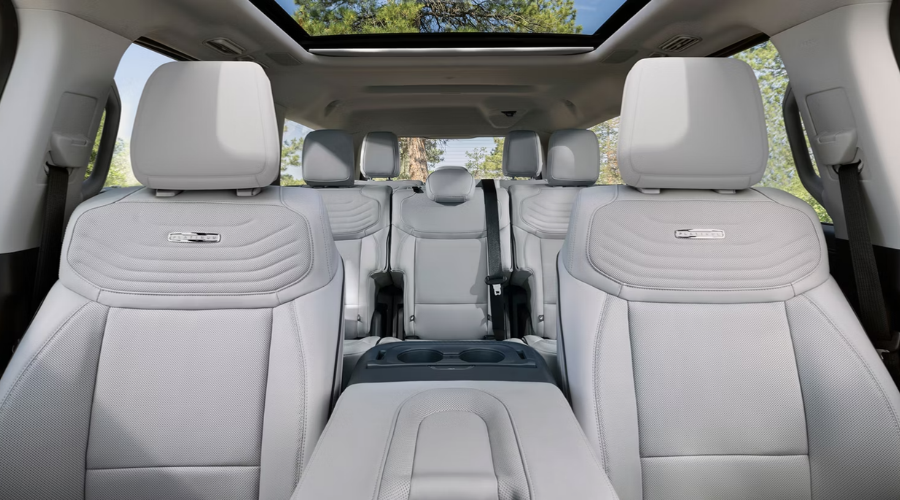 Interior view of the 2027 Ford Expedition Platinum showing Light Space Gray perforated leather seats, panoramic sunroof, three-row family seating, and center console at Salerno Duane Ford near Paramus, NJ.
