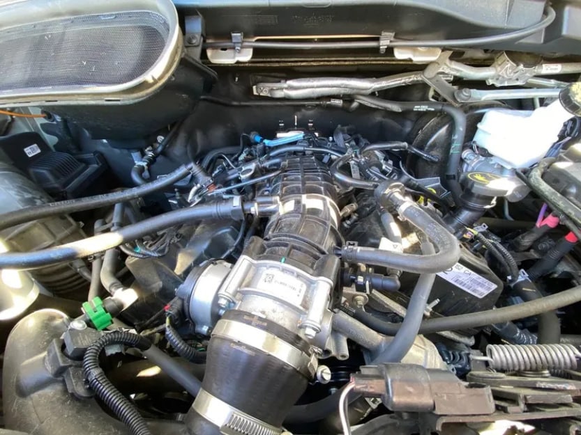 A hand turning an ignition key with a focus on the dashboard gauges.