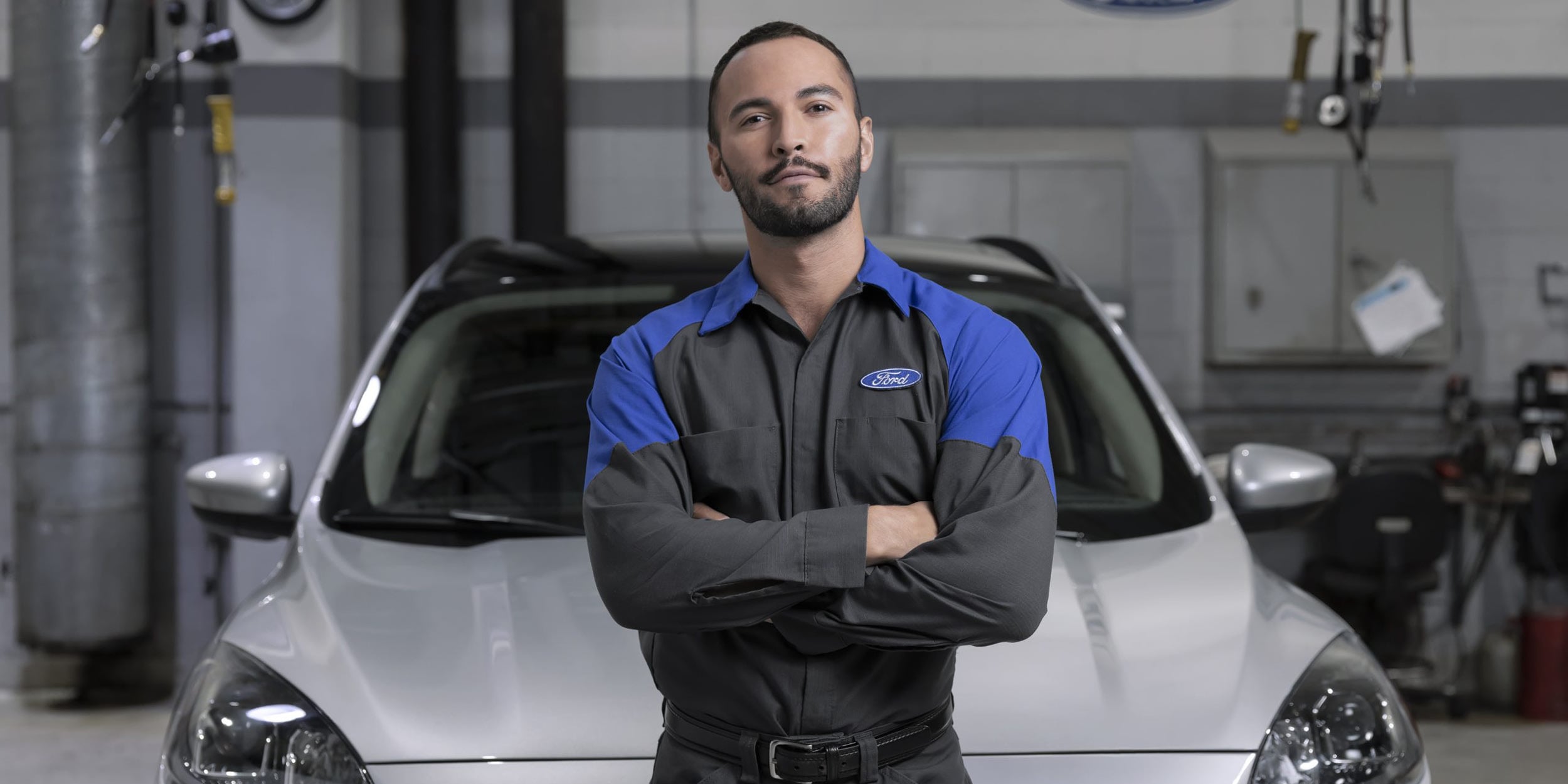 A certified Ford technician using high-tech diagnostic equipment on a modern vehicle dashboard in Santa Monica.