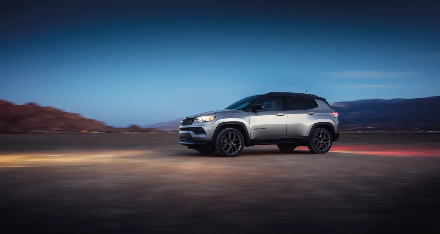 GRay Jeep Compass parked in desert view at dawn