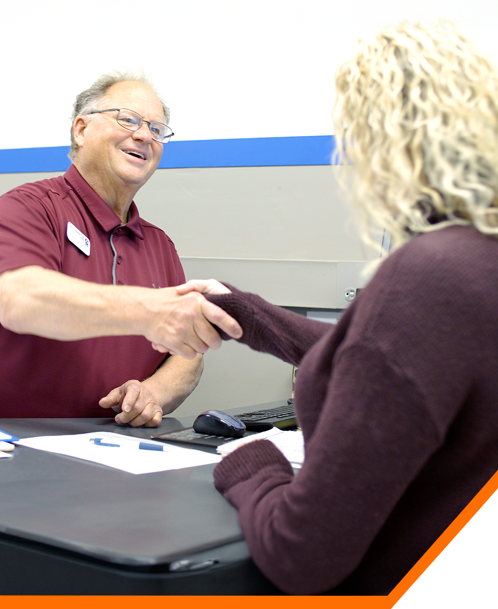 Employee and customer shaking hands
