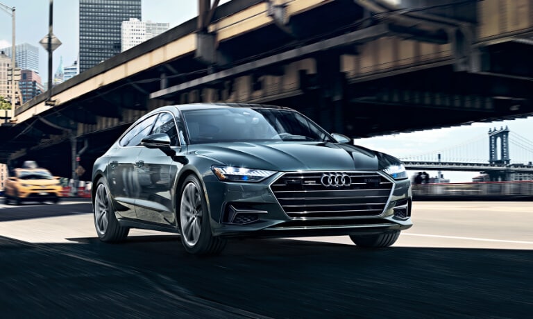 2020 Audi A7 driving alongside bridge