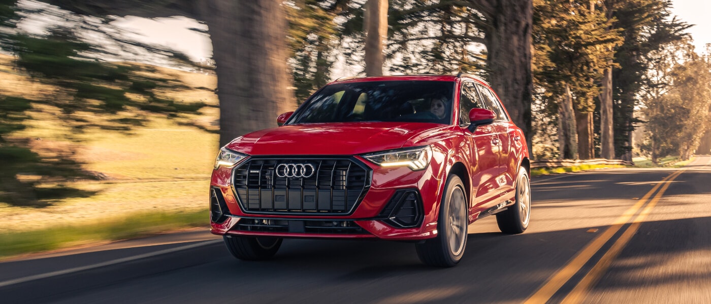 2024 Audi Q3 exterior driving on wooded road
