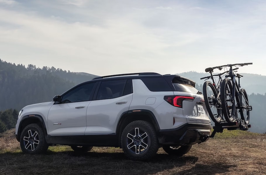 A white 2027 GMC Terrain SUV with a bike rack