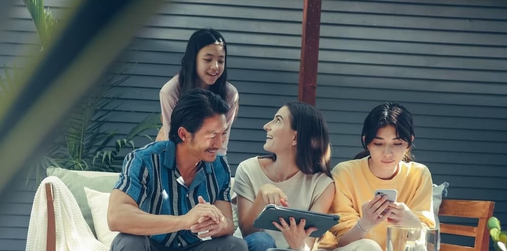 A family shopping for cars on a tablet